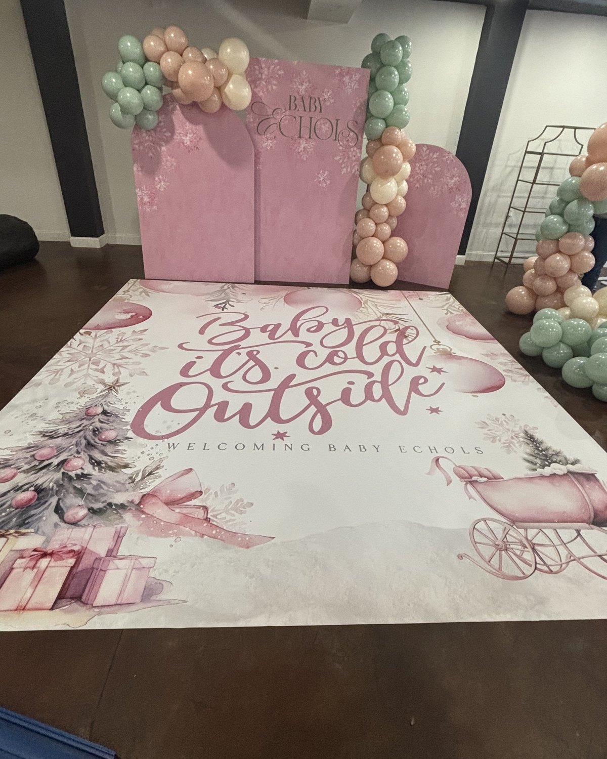 A pink Baby It's Cold Outside dance floor wrap we made for a winter baby shower